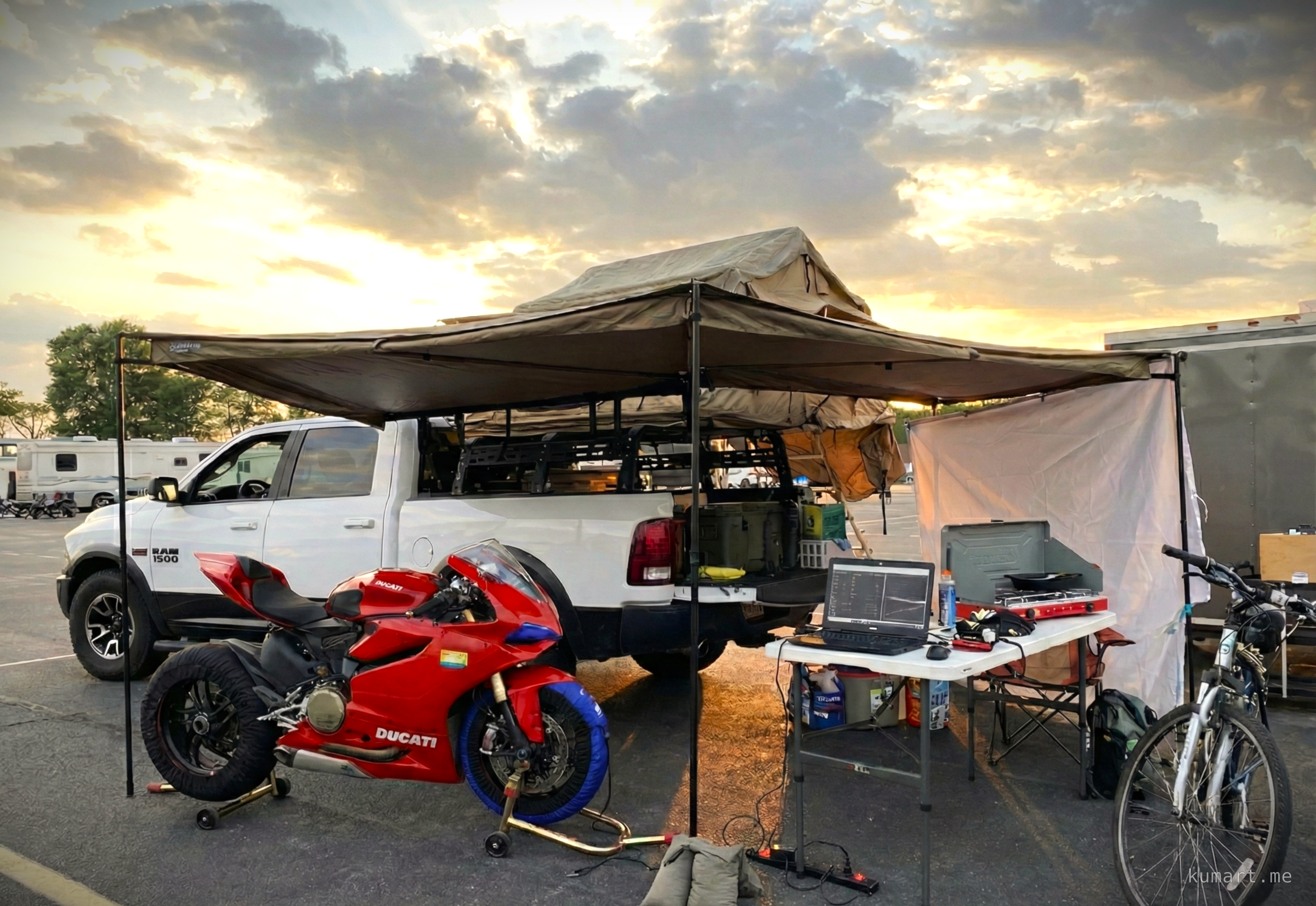 Track day paddock setup with laptop, tire warmers, and Ducati Panigale on rear stand